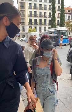 a woman wearing a face mask walking down the street