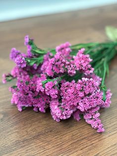 some purple flowers are laying on a table