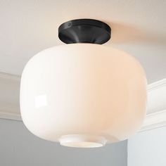 a white light hanging from the ceiling in a room