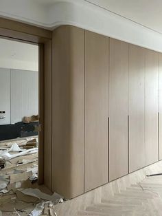 an unfinished room with wood floors and walls that have been torn apart from the wall