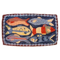 an image of a rug with fish on the front and back side in different colors