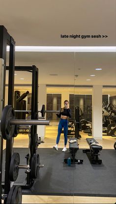 a woman standing in front of a gym machine