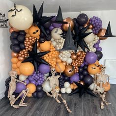 a halloween themed balloon wall with skeletons and stars