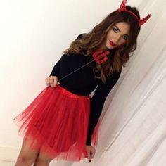 a woman in a devil costume posing for the camera