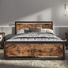 a bedroom with a bed made out of wooden planks and two nightstands next to it