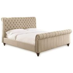 an upholstered bed with tufted headboard and foot board in beige fabric