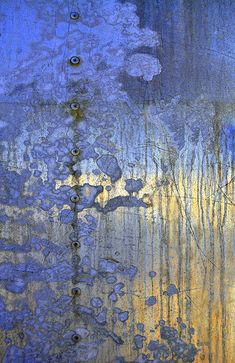 an abstract painting with blue and yellow colors on the side of a metal wall that has peeling paint all over it