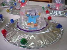 several plastic hats on top of a table with pom poms around the edges