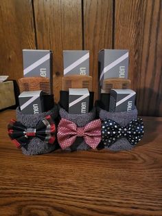 three pairs of socks with bows on them sitting next to each other in front of a wooden wall