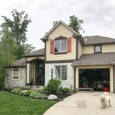 a dog is standing in front of a house