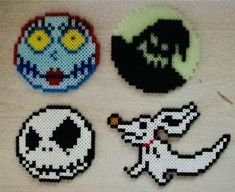 four different pixel art designs on a white surface