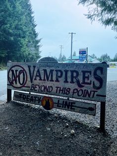 there is a sign that says no vampires beyond this point on the side of the road