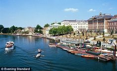 several boats on the water in front of some buildings