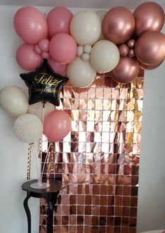 some balloons are hanging on the wall near a mirror