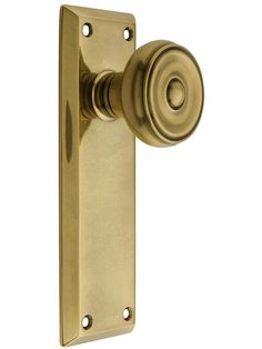 an antique brass door handle with a round knob