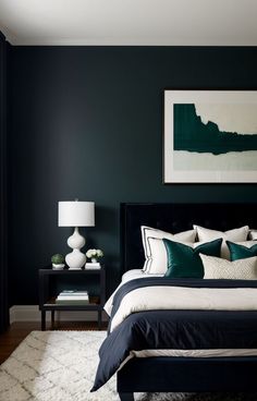 a bedroom with dark green walls and white rugs on the floor, along with a black headboard