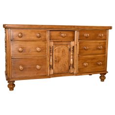 a wooden dresser with many drawers and knobs