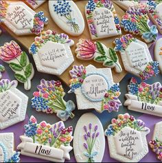 decorated cookies with words and flowers on them