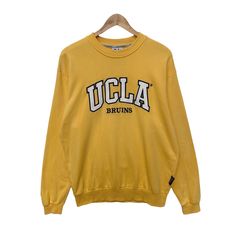 "PLEASE READ DESCRIPTIONS BEFORE BUYING. Contact me for questions about this cloth Vintage UCLA Bruins University Of California Sweatshirt Sweater Pullover Jumper Long Sleeve Medium Shirt Los Angeles College Yellow Mustard TAG BRAND:- UCLA SIZE ON TAG :- ACTUAL SIZE MEASUREMENT :- ARM PIT TO ARM PIT :23\" inches BACK COLLAR TO HEM : 24\" inches SLEEVE LENGTH : 26\" inches CONDITION :- Good used condition. No hole. Have some small black stains. Please refer the pictures. Please read the descripti Ucla Hoodie Outfit, Yellow Cotton College Sweatshirt, Ucla T Shirt, Ucla Sweatshirt, Vintage University Crewneck, California Sweatshirt, Ucla Bruins, Yellow Mustard, Black Stains