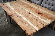 a wooden table sitting on top of a cement floor