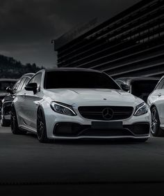 three mercedes cars parked in front of a building