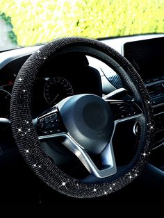 the steering wheel cover is decorated with sparkling beads and sequins on it's dashboard