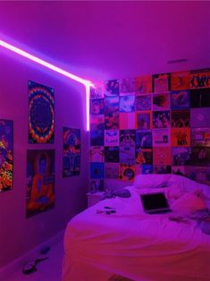 a bedroom with purple lighting and pictures on the wall