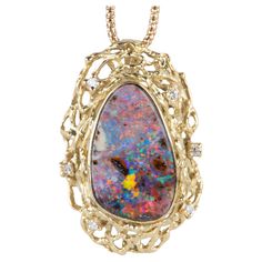 ♥ The face of the design measures 18.4mm in width (East West direction), 28.7mm in length (North South direction), and sits 8.2mm tall ♥ Material: 18k yellow gold; weighs 10.38g ♥ Gemstone: Natural Australian opal 7.285ct, diamonds 0.07ctw ♥ It comes with a 20" 18K gold necklace chain (as shown in the photo). ♥ Note: This is a preowned piece that may have signs of wear and tear, and minor discoloration due to its age. This piece may or may not have been polished or sized previously. 18k Gold Necklace, Australian Boulder Opal, Australian Opal, Boulder Opal, Gold Chain Necklace, Opal Jewelry, Diamond Pendant, Chains Necklace, 18k Gold