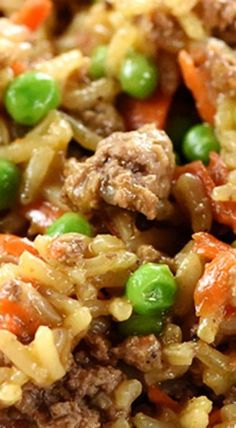 a close up view of rice with meat and vegetables