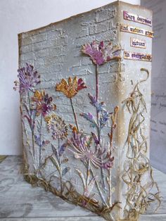 an altered book with flowers on it