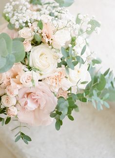 a bridal bouquet with white and pink flowers