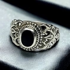 Pretty vintage ring in an ornate Sterling silver setting with an oval bezel set black center stone. Size 6 US. Weight is 3 grams. Stamped "925" along with the maker's hallmark. In excellent vintage condition! Vintage Black Filigree Rings, Black Oval Filigree Ring For Formal Occasions, Vintage Black Oval Cabochon Ring, Ornate Black Sterling Silver Rings, Black Oval Ring With Intricate Design, Black Oval Rings With Intricate Design, Vintage Black Oval Filigree Ring, Victorian Black Oval Rings, Ornate Black Oval Ring