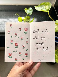 a hand holding up an open book with flowers on it and the words dear much, what you want to eat