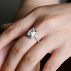 a woman's hand with a diamond ring on it