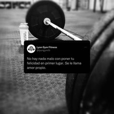 a black and white photo of a barbell on the ground