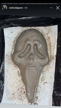 an image of a creepy mask made out of chocolate icing on a sheet of paper