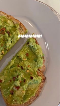 an avocado toast on a white plate with the words mmm