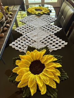 crocheted table runner with sunflowers on it