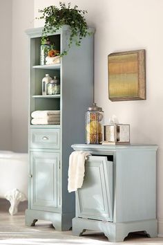 a blue cabinet sitting next to a white bath tub