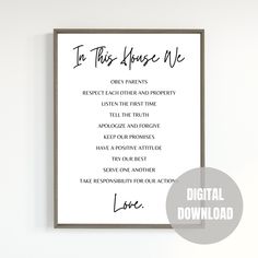 a white poster with the words in this house we are on it and a gray frame