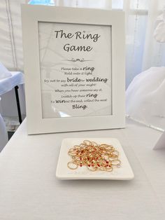 the ring game is set up on a table next to a plate with wedding rings