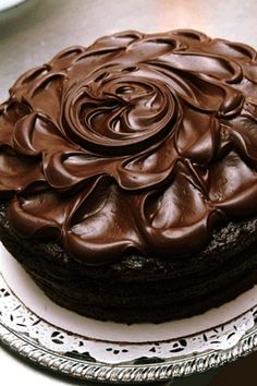 a chocolate cake sitting on top of a white plate