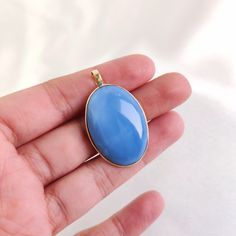 ITEM DESCRIPTION: >> The Pendant is made from Solid 14K Yellow Gold. Gemstone used is absolutely natural and ethically sourced. >> Natural Blue Opal in cabochon cut and oval shape with bezel setting is studded on it with utmost precision.  >> This is a minimalist design and is absolutely hassle-free and everyday jewelry.  Gem: Blue Opal Gem size: 21x30 mm oval Gem weight: 22.91 carats Gold purity: 14K (58.33% approx.) Gold weight: 0.63 grams  Gross weight: 5.19 grams The Gold purity is guaranteed and it comes with authentic 14K gold hallmark. Since this Pendant is handmade, It is Nickel/Lead FREE.  CUSTOMIZATION: --> You can choose your own gemstone. --> The same pendant can be made in thicker bezel as well. --> Kindly drop a message for more options. CUSTOMER SUPPORT: --> We are available Blue Oval Pendant Necklace With Polished Finish, Blue 14k Gold Oval Cabochon Jewelry, Blue Oval Pendant Jewelry With Polished Finish, Blue Jewelry With Large Oval Pendant, Blue Oval Pendant With Polished Finish, Elegant Blue Gemstones With Polished Finish, Oval Light Blue Jewelry For Gift, Light Blue Oval Jewelry For Gift, Blue Jewelry With Large Pendant For Formal Occasions