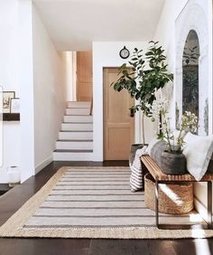 a living room filled with furniture and a rug