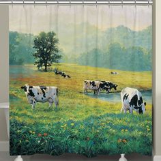 a shower curtain with cows grazing in a field