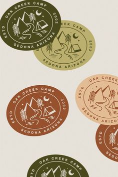 four circular stickers with different types of camping related items in the middle one is brown, green and orange