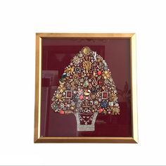 an ornately decorated christmas tree in a gold frame