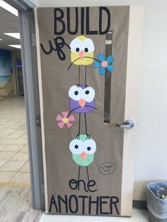 a door decorated with an image of birds and the words build up one another