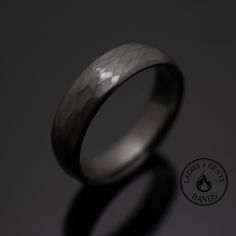 a wedding ring is shown on a dark background