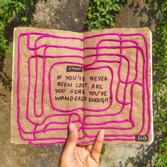 someone is holding an open book with pink thread on it and the words if you've never been lost, are you sure to be wondering enough